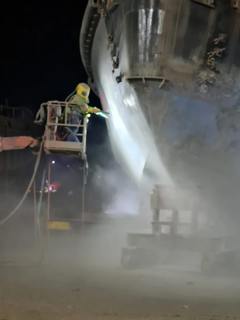 Sandblasting nocturno en casco de buque
